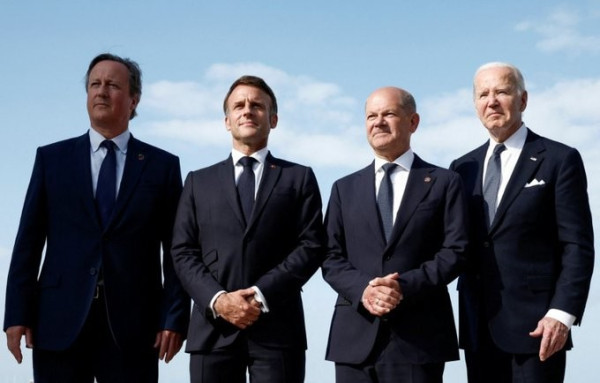 Foreign Secretary David Cameron standing with world leaders at the D-Day event
