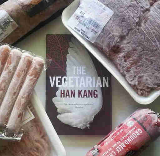 The Vegetarian book, surrounded by packs of meat.
