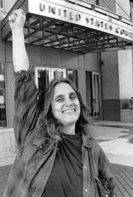 Judi Bari gives the raised fist salute outside the Oakland Federal Courthouse after winning a round in her civil rights lawsuit against the FBI and Oakland Police on March 3, 1995. By Photo by Xiang Xing Zhou, staff photographer for the San Francisco Daily Journal legal newspaper. Copyright 1995 San Francisco Daily Journal., Fair use, https://en.wikipedia.org/w/index.php?curid=842985