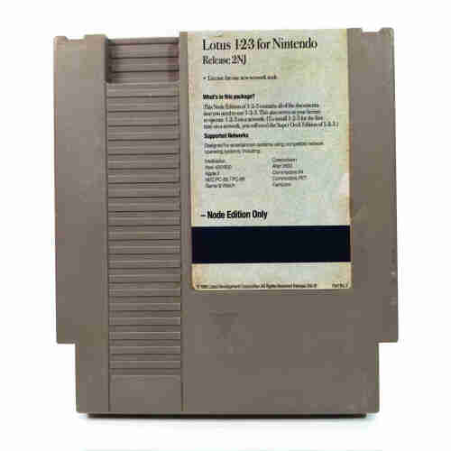 A photo of a NES cartridge for Lotus 1-2-3 for Nintendo - Node Edition, on a white background with an old partly torn label.