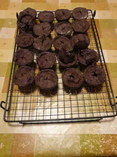 A batch of freshly-cooked mince pies. The pastry is brown due to the incorporation of cocoa powder.