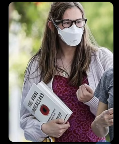 Violet Affleck, daughter of Ben, in a respirator, carrying a copy of Steven Thrasher's The Viral Underclass.