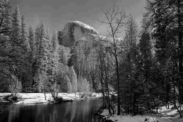 Half Dome Infrared

This is an image of Half Dome in Yosemite Valley.
The sky is clear without a whisper of wind. 
A winter storm blew through the valley the day before but now the winds are almost completely still. 
The Merced River starts in the foreground of the image and moves towards the back, leading you eye into the frame.
Both sides of the river are lined with mostly pine trees with a few hardwoods mixed in. The branches of the trees are covered in snow as is the ground on both sides of the river.