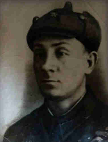 A portrait photo of a young men in Soviet army uniform from the period of world war two.