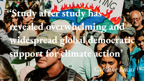 A climate demonstration, with a quote from Caroline Lucas's blog: 'Study after study has revealed overwhelming and widespread global democratic support for climate action'