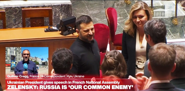 Zelensky shaking hands with the members of the French Parliament just before his speech 