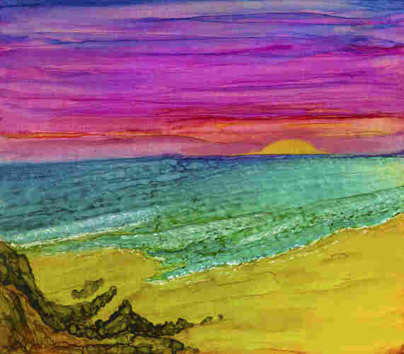 Seascape. Vibrant Beach Sunset alcohol ink art. As though lit from within, the colors of the painting jump off the canvas. The sun, a ball of glowing yellow sinks into an aqua sea, appearing to illuminate the water from below and setting fire to the sky above in shades of orange, pink and purple. Warm golden sand makes up the foreground with dark, rough rocks anchoring the painting on the left.