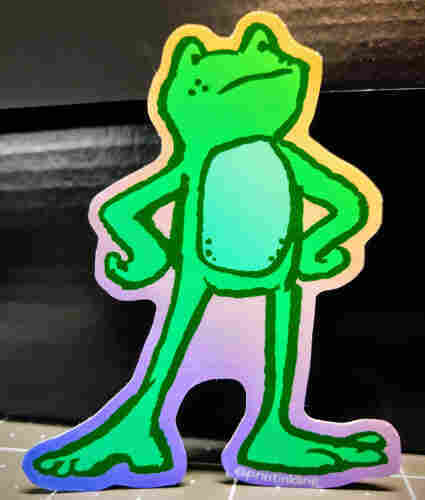 A defiant frog sticker of a cartooned green frog standing with hands on hips. He has dark green speckles and isn't up for any of your nonsense 