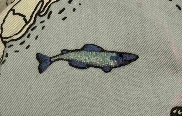 A small blue embroidered fish