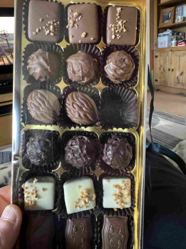 Picture a gold effect box full of praline chocolates- one is missing from the original 18!