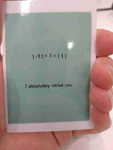 Photo of card. It is a plain color with two lines of text.

"| -1 | = 1 = | 1 |"

"I absolutely value you"