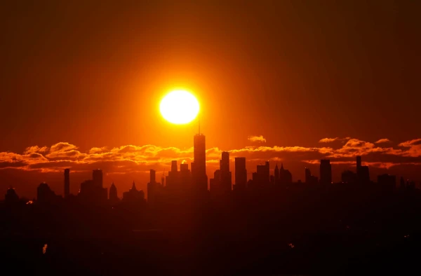 The sun rises behind the red-tinted skyline of lower Manhattan in New York City, on January 21, 2024.
Gary Hershorn / Getty Images
