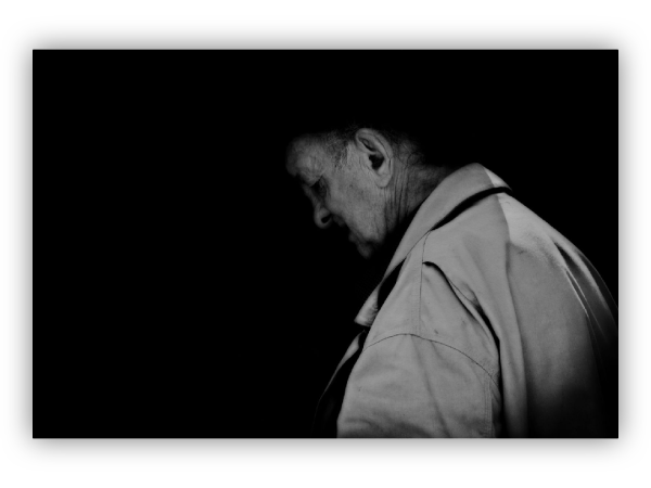 Elderly man in the dark.