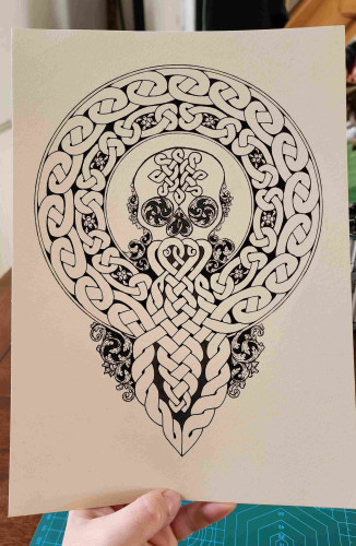 A skull with a big celtic knot moustache and beard that twists into a circular frame around its head, drawn in black ink on cream coloured paper 
