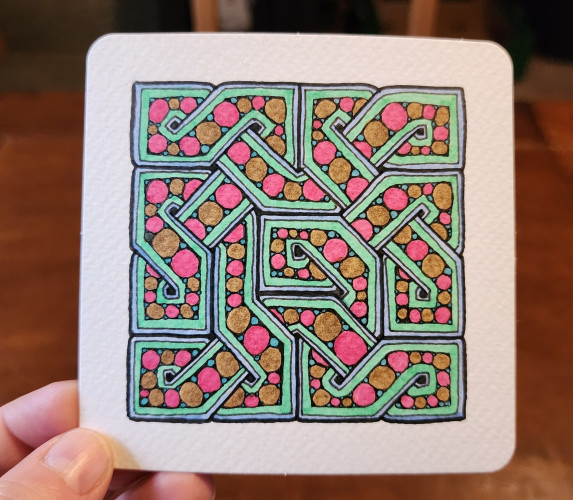 A celtic knot drawn on square paper. It's filled with circles coloured in teal, brown, and pink, with a mint green and light blue border. The knot is made from the 'cool S' shape, repeating to form a packed square shape.