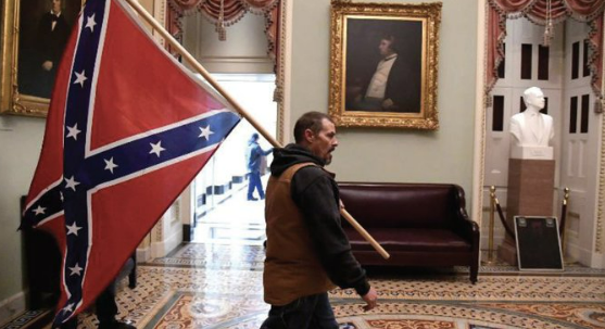 Seefried carrying confederate battle flag in our Capitol on J6