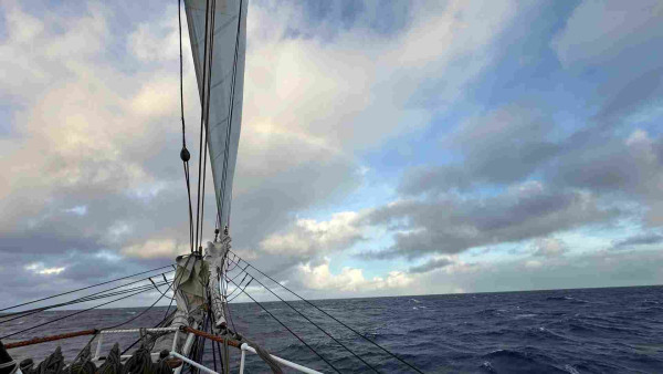  Ship bowsprit and a small rainbow on the horizon 