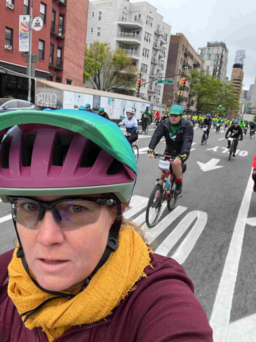 Just past the starting point near Hudson Square in Manhattan, 35,000 bike riders start the five borough bike tour. The streets have been cleared of cars, and there are 100s of riders in the shot.