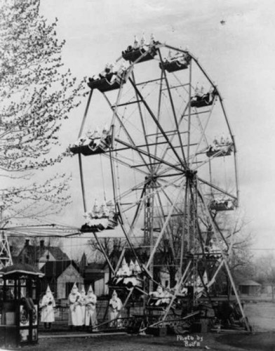 Old photo of a Ferris Wheel full of robed Klansmen