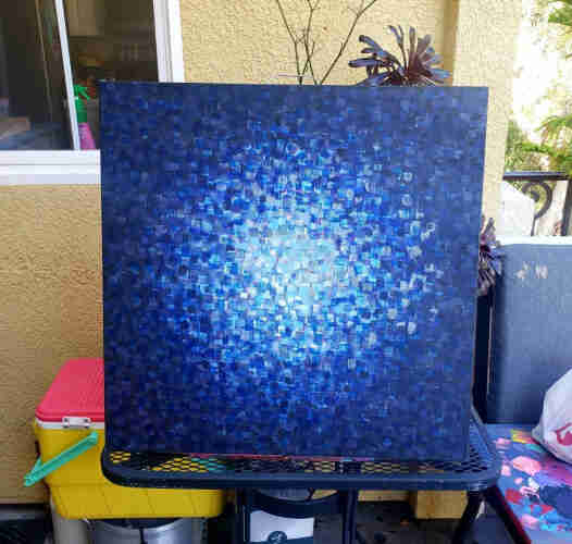 A painting of a black background, with dark blue paint, dabbed around the edges of the frame, increasingly going inwards the center decreasing in the shade of color until it hits the center.