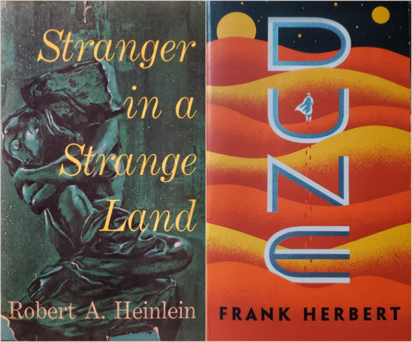 A 1960s book club edition of Robert A. Heinlein's "Stranger in A Strange Land," alongside a 2010s paperback of Frank Herbert's "Dune."