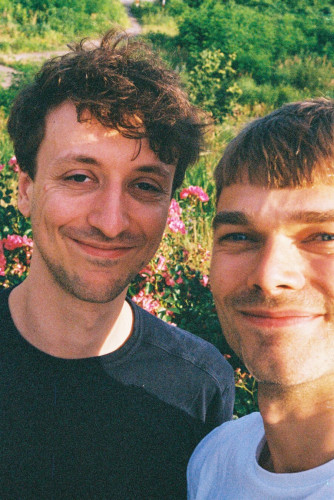 A selfie type photo of two smiling guys