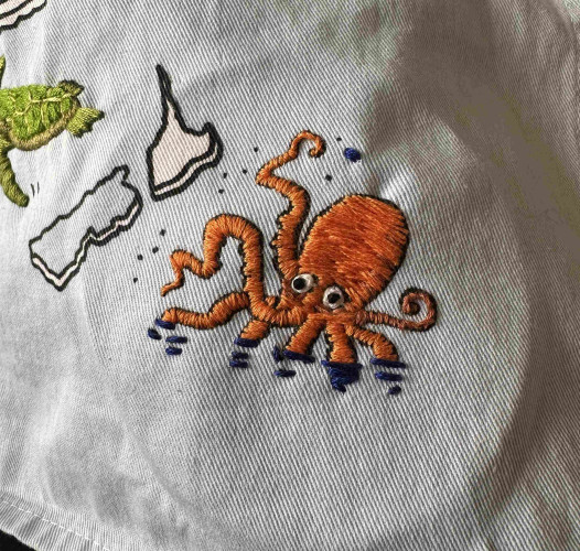 A small orange embroidered octopus 