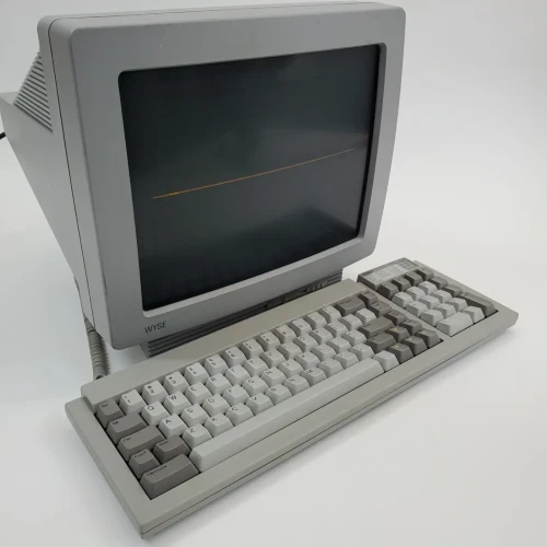 a monochrome (amber) crt terminal and keyboard.
The display is showing a single horizontal line of varying intensity across the vertical center of the display