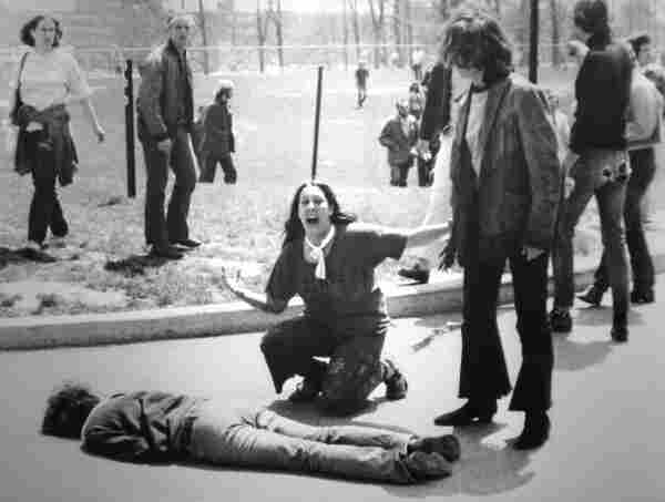 Student kneels over a dead body at Kent State after a protester is shot by the National Guard in 1970. 