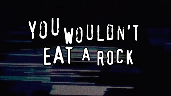 Meme in the style of those mid-2000s anti-piracy PSAs with white typewriter text on a glitchy blue background, but it reads "You wouldn't eat a rock".