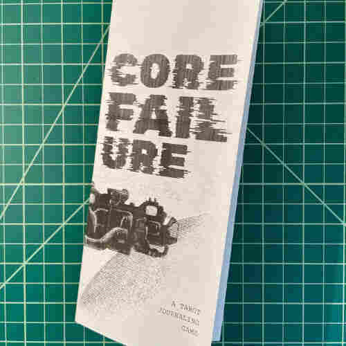 A trifold pamphlet reading Core Failure: A Tarot Journaling Game with a picture of a spaceship.