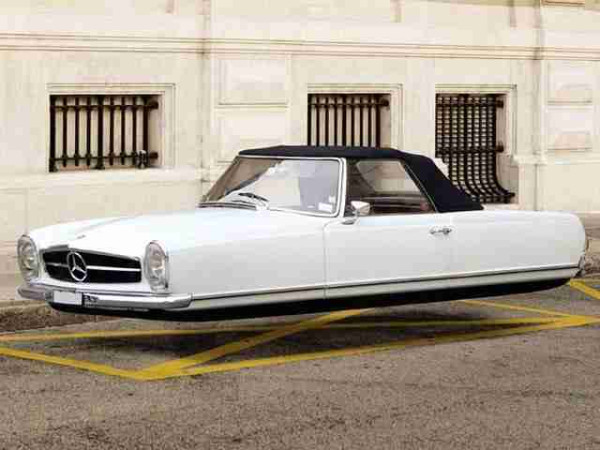 color photo of white Mercedes auto with no wheels 