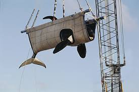 "baby shamu" in canvas sling, being lifted by a crane

from URL
https://theorcaproject.wordpress.com/about-2/