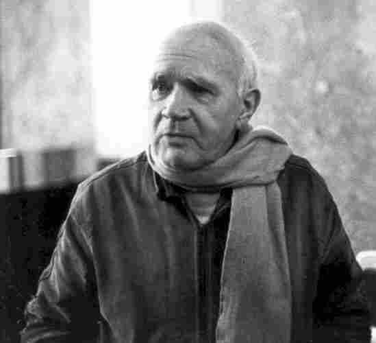 Jean Genet in 1983, balding and wearing a scarf. By International Progress Organization - http://i-p-o.org/genet.htm, CC BY-SA 3.0, https://commons.wikimedia.org/w/index.php?curid=8499473