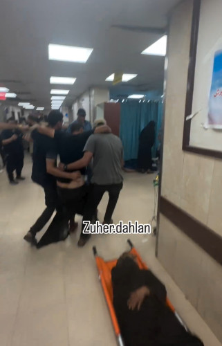 palestinians carrying injured truck driver to the hospital
