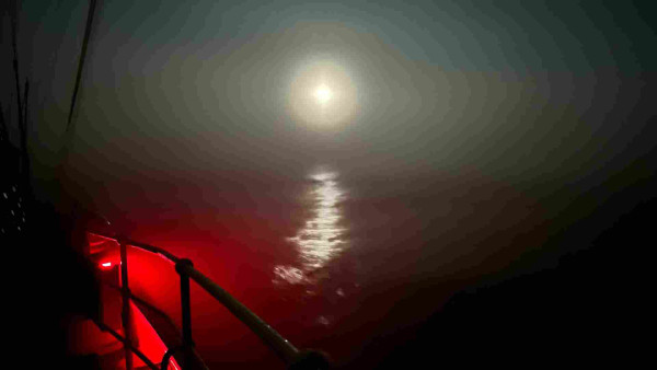 Moonlight through fog with red marker light 