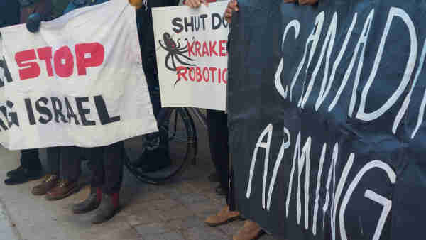 Protest banners reading: 
Canada Stop Arming Israel 

And 
Shut down Kraken Robotics 