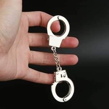A pair of Trump sized handcuffs, aka Policewoman Barbie handcuffs™️