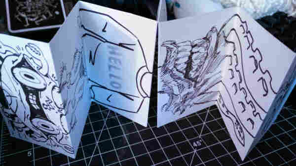 A zine folded accordion style featuring art by erbmaster, killdozer, and rapidpunches.