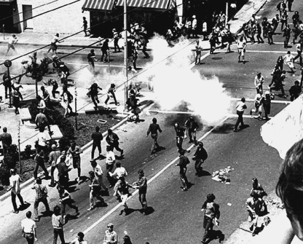 Bloody Thursday street battle, Telegraph Ave., near People's Park, with tear gas, smoke, cops with truncheons.