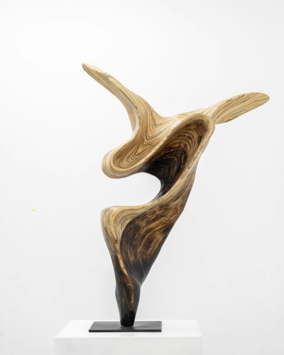 Wooden sculpture of slender, curving forms and wing-like tips 