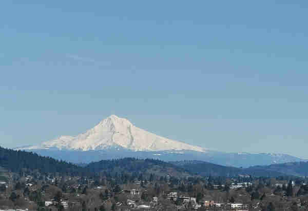 Mount hood, looking real nice. Covered in snow with full, bright sun and a clear sky