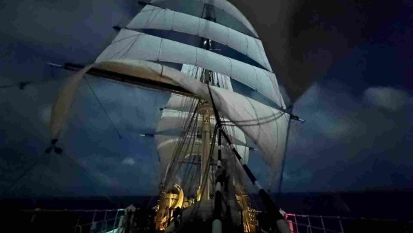 Long exposure of a tall ship viewed from the fore deck underneath the main mast. 