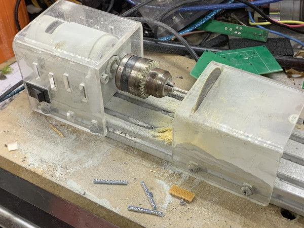 A bead lathe with cutting disc surrounded by the shards of trimmed PCBs