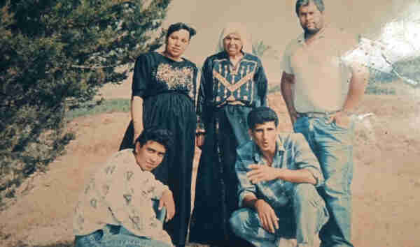 A photo of a group of people: Tamam Abusalama’s mother and paternal grandmother, along with other members of her extended family. (Photo courtesy of Tamam Abusalama) 