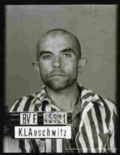 A fragment of the mugshot photo of an Auschwitz prisoner. A man in striped-jacket. The camp number 45921 is visible on the board.