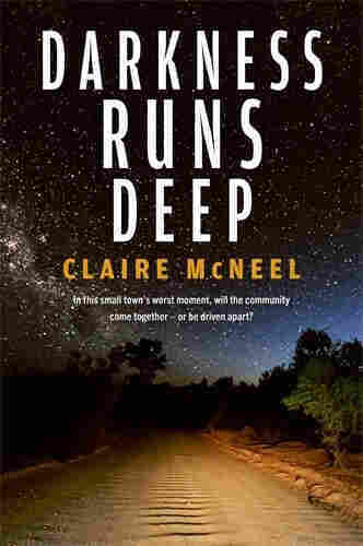 Image of the book cover for Darkness Runs Deep by Claire McNeel with the subtitle "In this small town's worst moment, will the community come together - or be driven apart?"

The background image is dominated by a dark sky filled with stars, sitting over a wide gravel road that's rutted down one side. The road and the trees to the side are lit up as they would be from a vehicle's headlights.
