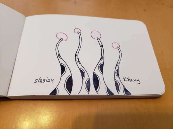 Hand drawn generative/iterative art in ink on an open page of my sketchbook. The abstract pattern is difficult to describe, but it looks a bit like polka-dotted tentacles reaching up from the bottom of the page and there are pink puf-balls at the ends of them.