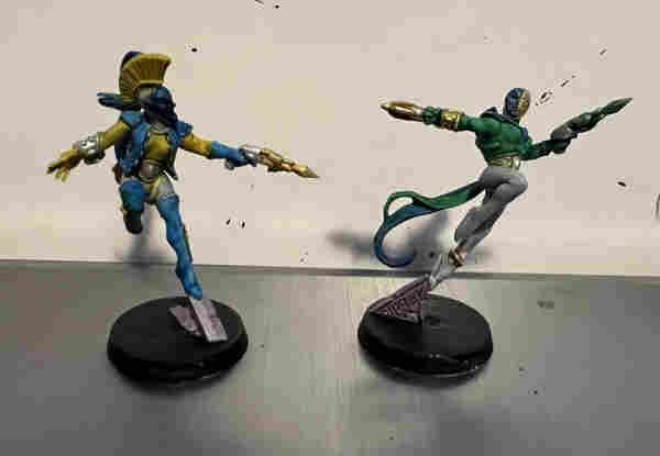 Warhammer 40K Miniatures 

Two harlequins, one yellow and blue, the other green and blue. 