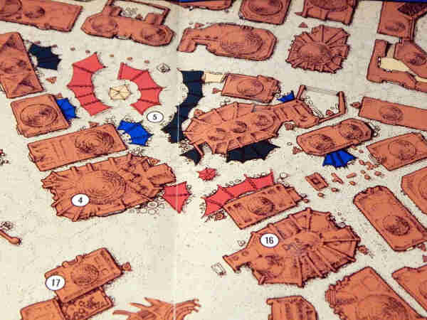 Close-up of a map of Mos Eisley starport created for West End Games by the late Jennell Jaquays. The top-down map shows desert buildings with butresses and domes, colorful awnings in the market, and bits of junk in the alleys and corners.